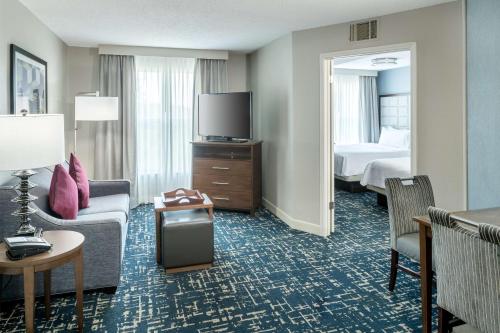 a hotel room with a bed and a tv and a room at Homewood Suites by Hilton Austin NW near The Domain in Austin