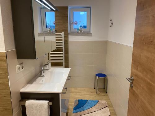 a bathroom with a sink and a mirror at Ferienwohnung mit Salzachblick in Laufen