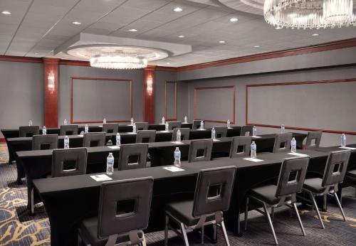 a conference room with a long table and chairs at Hilton Garden Inn Las Colinas in Irving