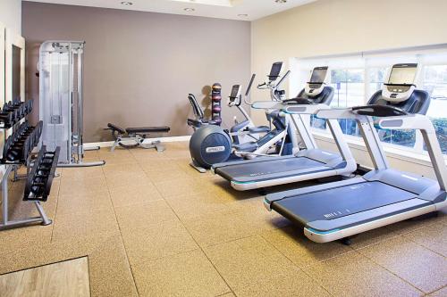 a gym with several cardio machines in a room at Embassy Suites by Hilton Destin Miramar Beach in Destin