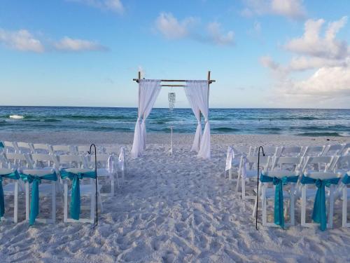 a wedding ceremony set up on the beach at Embassy Suites by Hilton Destin Miramar Beach in Destin