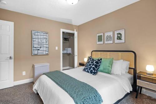 a bedroom with a large bed with green pillows at Pittsburgh Gem - 5BR - Downtown Deck View in Pittsburgh