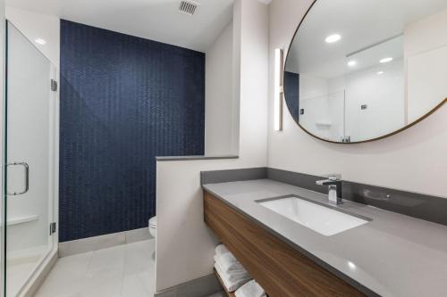 a bathroom with a sink and a mirror at Fairfield by Marriott Inn & Suites Knoxville Clinton in Clinton