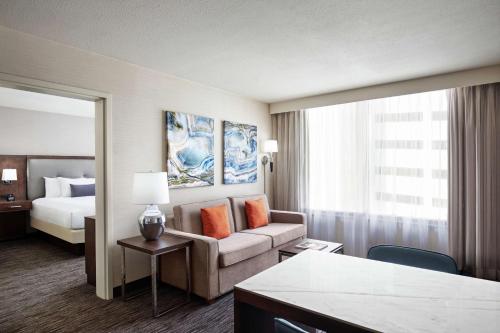 a hotel room with a bed and a couch at Embassy Suites Fort Worth - Downtown in Fort Worth