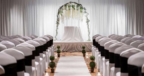 a row of chairs in a room with a altar at Hilton Indianapolis Hotel & Suites in Indianapolis