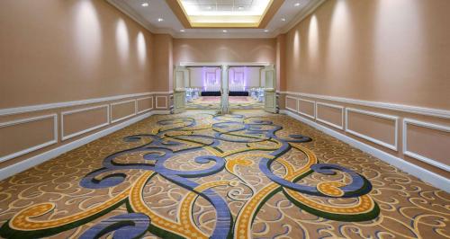 a room with a carpet with a design on the floor at Hilton Indianapolis Hotel & Suites in Indianapolis