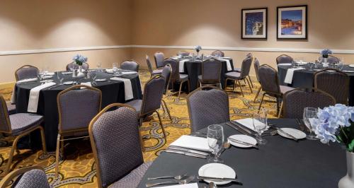 a conference room with tables and chairs and tablesktop at Hilton Indianapolis Hotel & Suites in Indianapolis