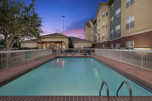 a swimming pool in front of a building at Homewood Suites by Hilton Lubbock in Lubbock