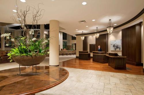 a lobby with a table with a potted plant at Embassy Suites San Antonio Riverwalk-Downtown in San Antonio