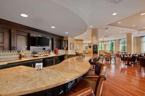 a large lobby with a bar and a restaurant at Embassy Suites San Antonio Riverwalk-Downtown in San Antonio