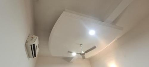 a room with a white ceiling with a ceiling fan at Hotel Surya inn in Raipur