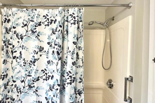 a shower curtain with a black and white flower pattern at Central & direct snowmobile access in Gorham