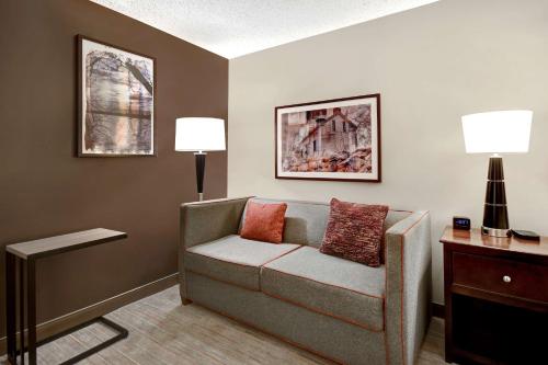 a living room with a couch and two lamps at Hampton Inn & Suites Alexandria Old Town Area South in Alexandria