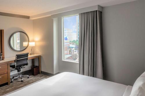 a hotel room with a bed and a desk and a window at DoubleTree by Hilton New Orleans in New Orleans