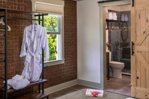 a bathroom with a robe hanging on a wall at The Inn At Amaris Farms in Weaverville