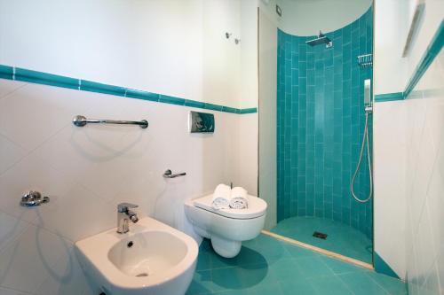 a bathroom with a sink and a toilet and a shower at Hotel Villa Sirena in Ischia