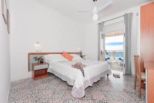 a bedroom with a bed with a view of the ocean at Hotel Villa Sirena in Ischia