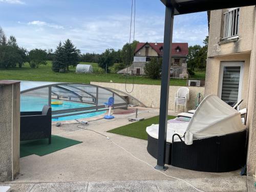a backyard with a swimming pool and a house at Chambres d hôtes 