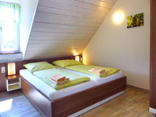 a small bedroom with a bed in a attic at Weinbau & Pension – Familie Birgit und Bernhard Meusert in Volkach