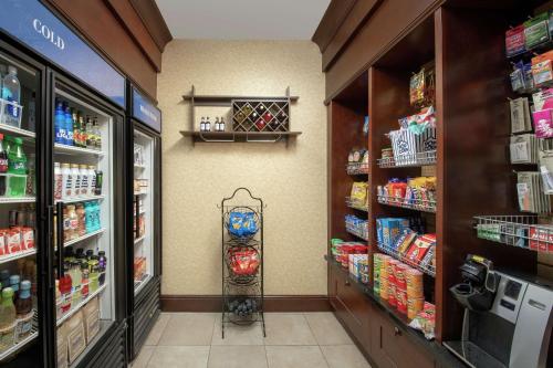 a grocery store aisle with a drink cooler in a store at Hilton Garden Inn Odessa in Odessa