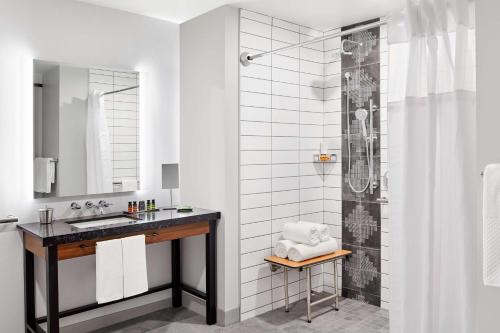 a bathroom with a sink and a shower at Canopy By Hilton Tempe Downtown in Tempe