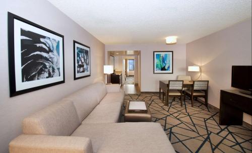 a living room with a couch and a table at Embassy Suites by Hilton Portland Tigard in Tigard