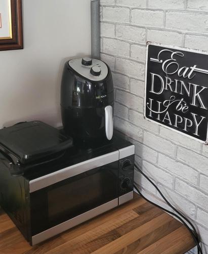 a coffee maker sitting on top of a microwave at Atlantic Coast Lodge in Spanish Point