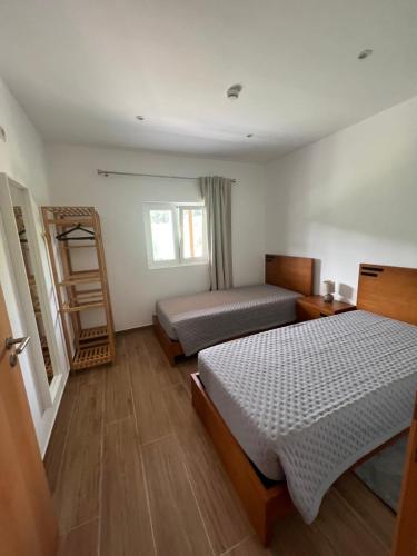Funileiro, apartamentos e quartosにあるベッド