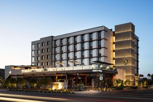 a building on a street with a road in front of it at Senna House Hotel Scottsdale, Curio Collection By Hilton in Scottsdale