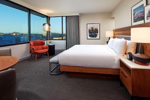 a hotel room with a bed and a large window at Senna House Hotel Scottsdale, Curio Collection By Hilton in Scottsdale