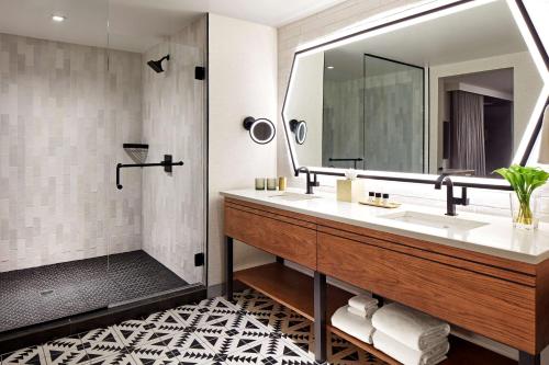 a bathroom with a sink and a mirror at Senna House Hotel Scottsdale, Curio Collection By Hilton in Scottsdale