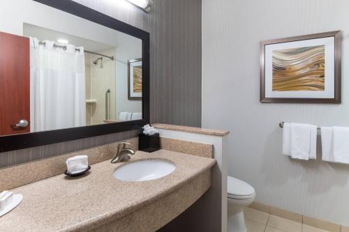 a bathroom with a sink and a mirror at Courtyard Fort Worth West at Cityview in Fort Worth