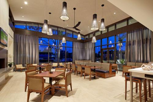 a restaurant with tables and chairs and large windows at Homewood Suites by Hilton San Diego Mission Valley/Zoo in San Diego
