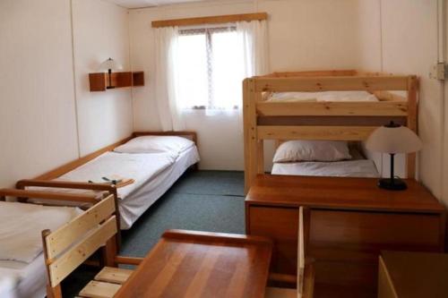 a room with two bunk beds and a table at Bungalovy Zvíkov in Zvíkovské Podhradí