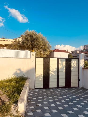 a black and white garage door on a white fence at Tirana View Apartments in Tirana