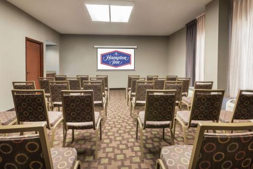 a room with rows of chairs and a sign at Hampton Inn Charlotte University Place in Charlotte