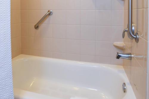 a white bath tub in a bathroom with a shower at Courtyard Cincinnati North at Union Centre in West Chester