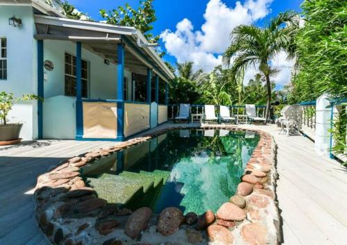 a swimming pool in the backyard of a house at Goat Hill & Goat Rock Studios in Cobbs Cross