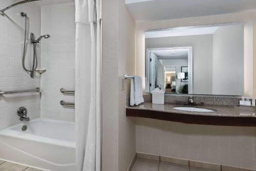 a bathroom with a tub and a sink and a shower at Homewood Suites by Hilton Houston-Clear Lake in Webster