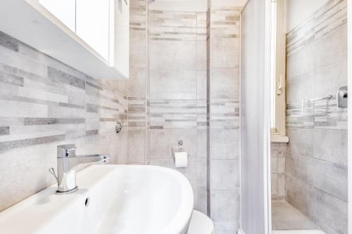 a white bathroom with a sink and a toilet at APARTMENT IN TRASTEVERE in Rome