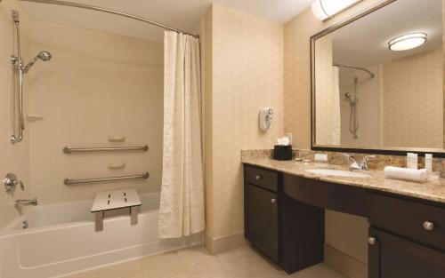 a bathroom with a tub and a sink and a shower at Homewood Suites by Hilton Houston - Northwest/CY-FAIR in Houston