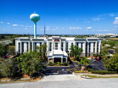 a large white building with a water tower at Hampton Inn & Suites Clermont in Clermont