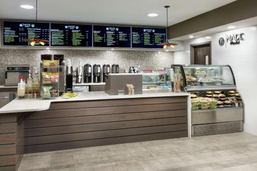 a fast food restaurant with a counter with food at DoubleTree by Hilton Orlando Airport Hotel in Orlando