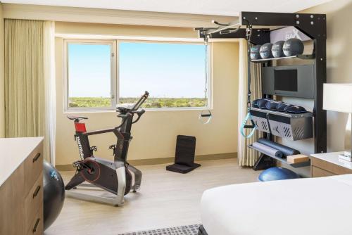 a room with a gym with a exercise bike at DoubleTree by Hilton Orlando Airport Hotel in Orlando