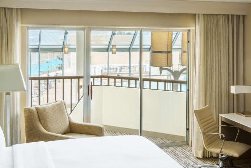 a hotel room with a bed and a balcony at DoubleTree by Hilton Orlando Airport Hotel in Orlando