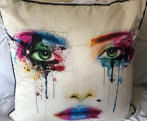 a close up of a woman with eyes on a pillow at Dinky cottage in Brightlingsea