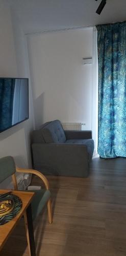 a living room with a couch and a table at LuxuryCity Apartment with Terrace in Wrocław
