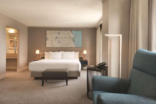 a hotel room with a bed and a couch at Hilton Chicago Magnificent Mile Suites in Chicago