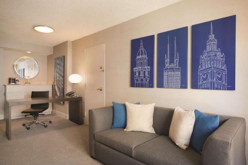 a living room with a couch and a desk at Hilton Chicago Magnificent Mile Suites in Chicago