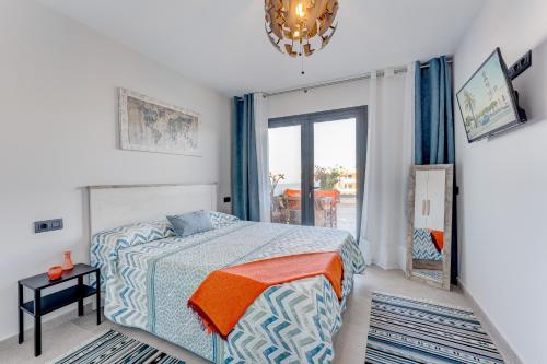 a bedroom with a bed with an orange blanket at Yuli in Puerto de la Cruz